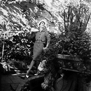 Images Dated 5th February 2016: Young woman modelling a suit in a garden