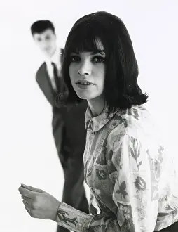 Focus Prints: A young woman poses in the foreground with an out of focus male standing behind