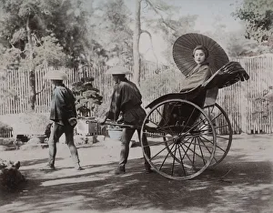 Jinrikisha Prints: Young woman being pulled in a rickshaw, Japan