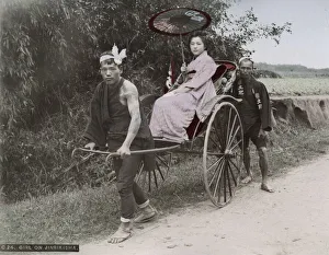 Young woman being pulled in a rickshaw jinrikisha