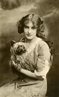 Young woman with small dog in studio portrait