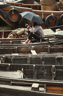 Images Dated 8th August 2019: A young woman on a small sampan wooden ferry boat
