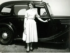 Snapshot Prints: Young woman standing by a car