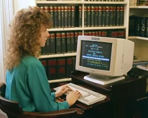 Images Dated 8th June 2017: Young woman working at a computer in a solicitors office