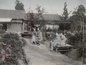 Young women sitting in a flower garden, Japan
