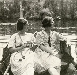 Checked Gallery: Two young women steering a barge on a river, England